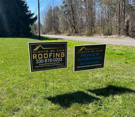 Roofing yard signs staked in lawn for storm restoration marketing