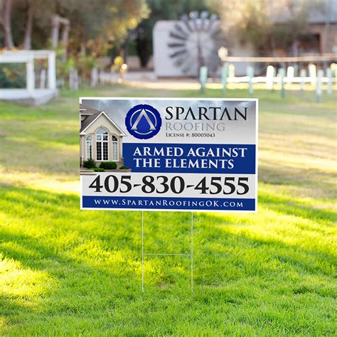 Large roofing contractor yard sign in residential lawn